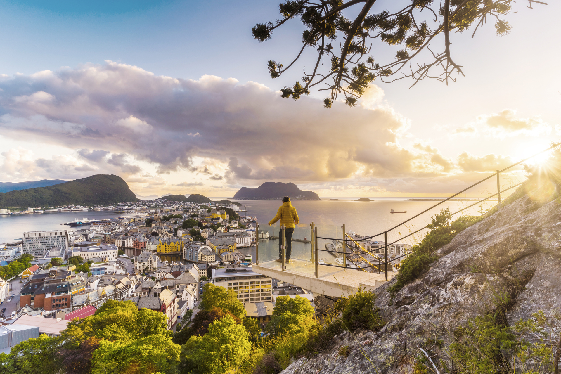Bilden visar en person som står på utsiktsplatsen där man ser hela Ålesund.

